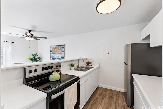 kitchen featuring white cabinets, sink, ceiling fan, appliances with stainless steel finishes, and dark hardwood / wood-style flooring