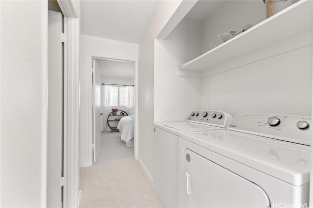 washroom with light carpet and independent washer and dryer