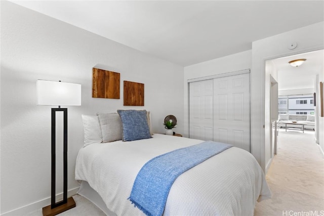 bedroom featuring light carpet and a closet