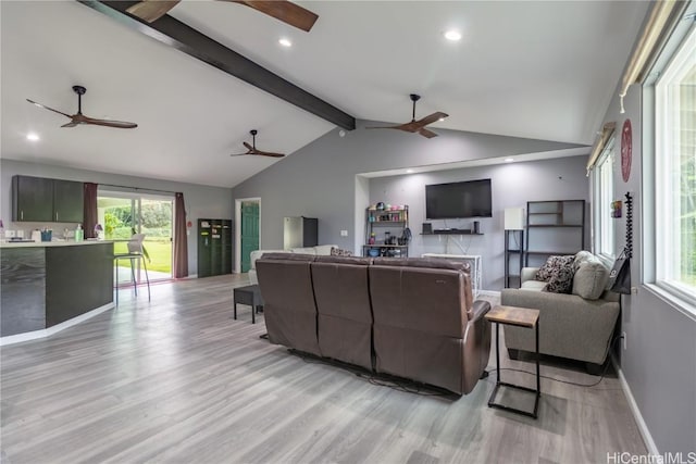 living room with lofted ceiling with beams and light hardwood / wood-style flooring