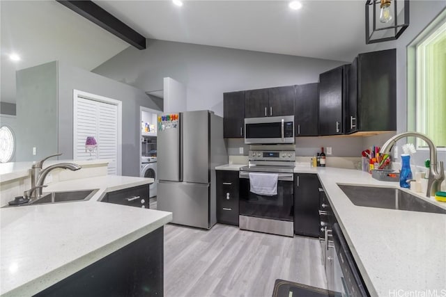 kitchen featuring lofted ceiling with beams, light wood-type flooring, sink, and appliances with stainless steel finishes