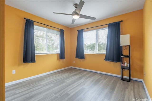 empty room with light hardwood / wood-style flooring and ceiling fan