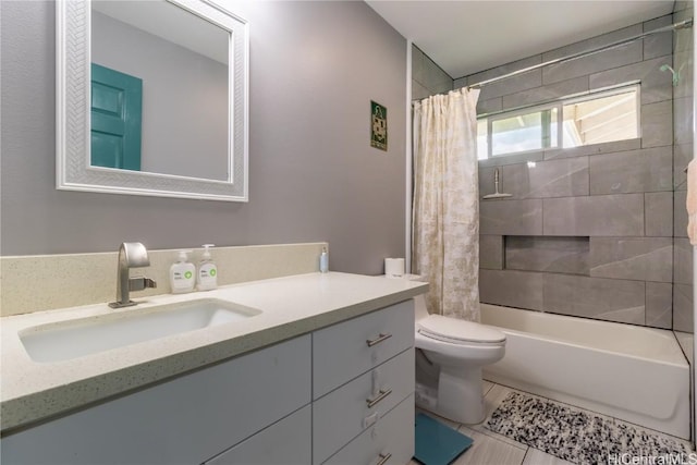 full bathroom featuring tile patterned flooring, vanity, toilet, and shower / tub combo with curtain