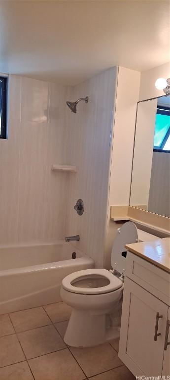 full bathroom with tile patterned flooring, vanity, tiled shower / bath combo, and toilet