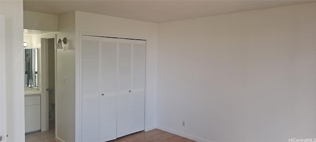 unfurnished bedroom featuring a closet and baseboards