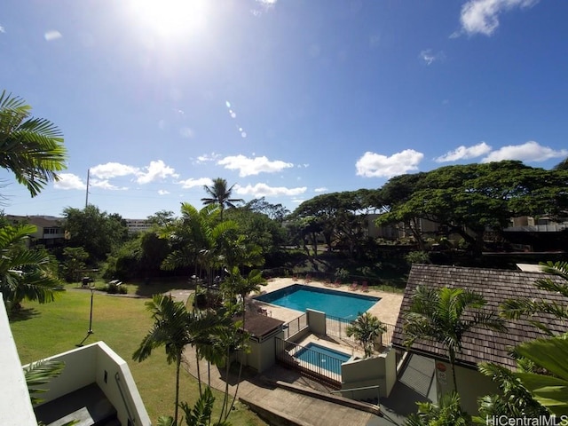 view of swimming pool with a lawn