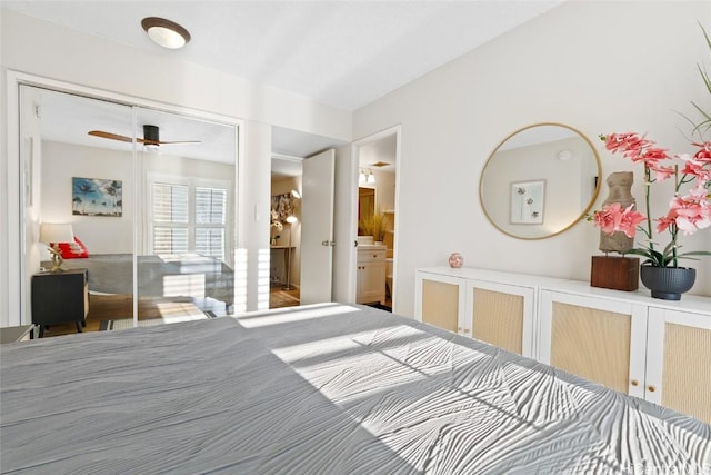 bedroom with ensuite bath and ceiling fan