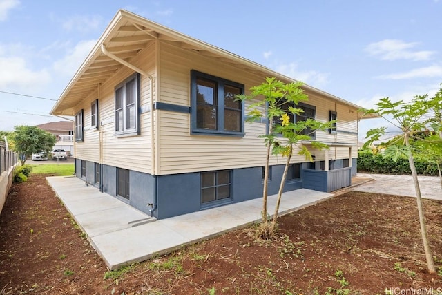 view of side of home with a patio area