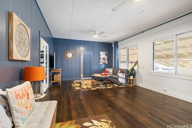 living area featuring ceiling fan and hardwood / wood-style flooring