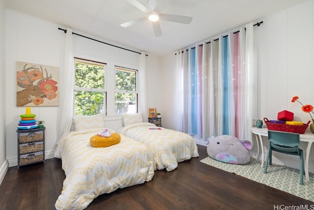 bedroom with dark hardwood / wood-style floors and ceiling fan