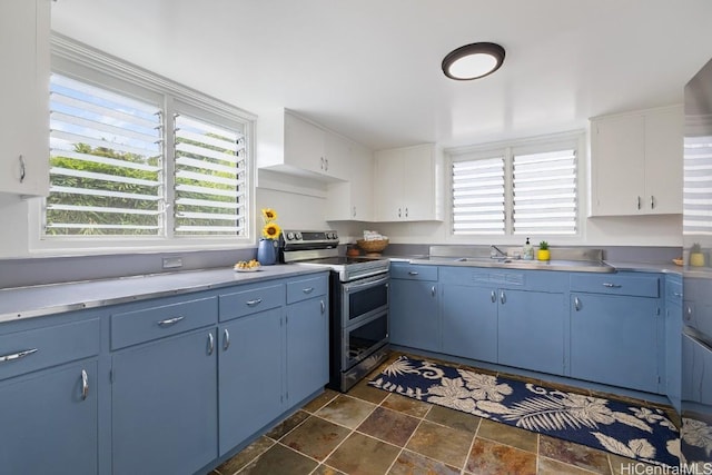 kitchen featuring white cabinets, sink, blue cabinetry, and electric stove