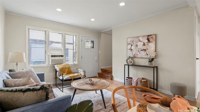 living area featuring crown molding, cooling unit, and light wood-type flooring