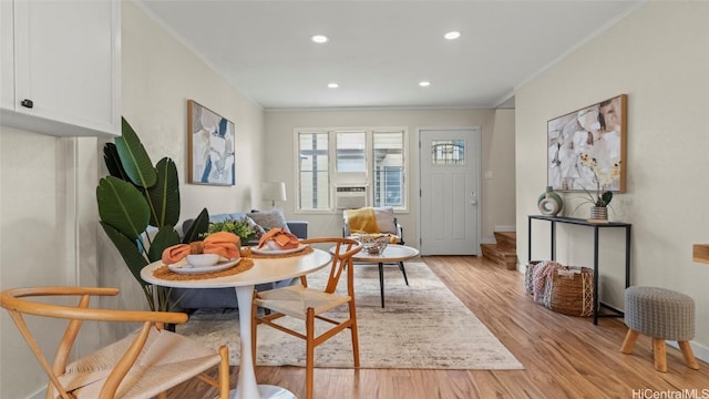 dining room with crown molding, light hardwood / wood-style flooring, and cooling unit