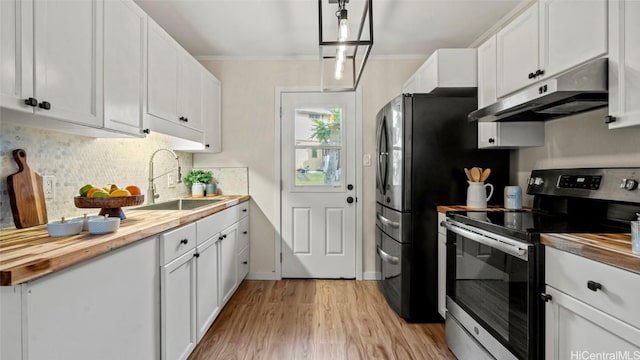 kitchen featuring stainless steel electric stove, butcher block counters, sink, and white cabinets