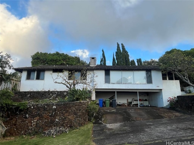 rear view of property with a carport