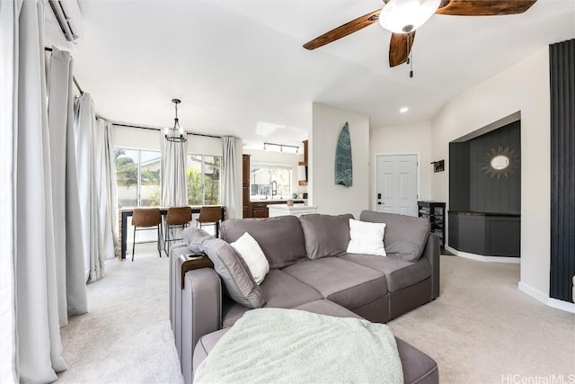 living room featuring light colored carpet and ceiling fan