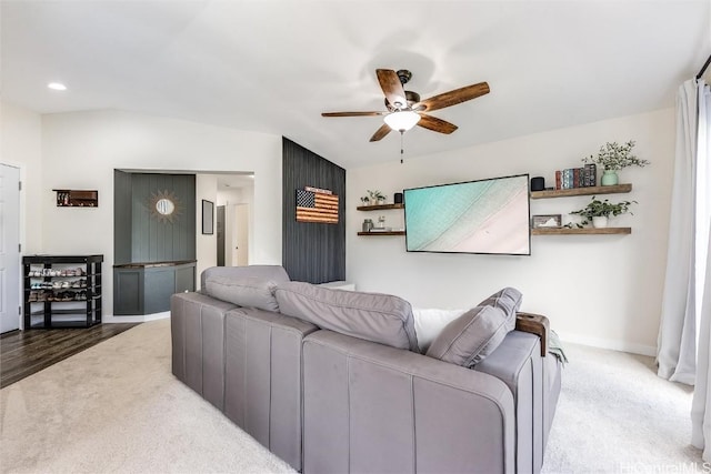 carpeted living room featuring ceiling fan and lofted ceiling