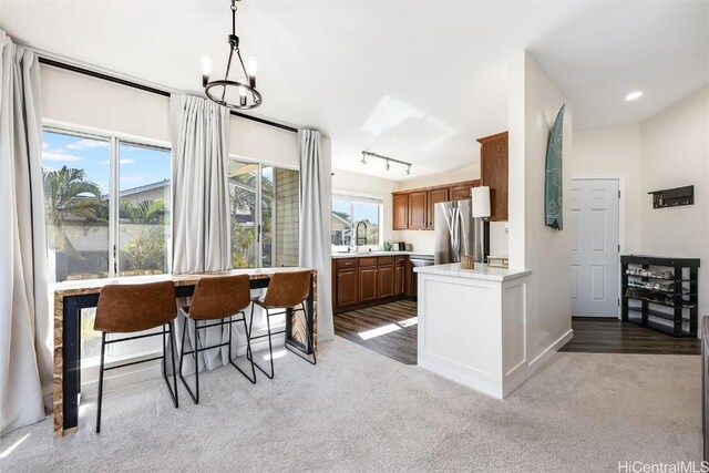 kitchen featuring stainless steel appliances, a healthy amount of sunlight, pendant lighting, and kitchen peninsula