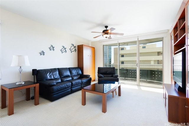 carpeted living room with ceiling fan