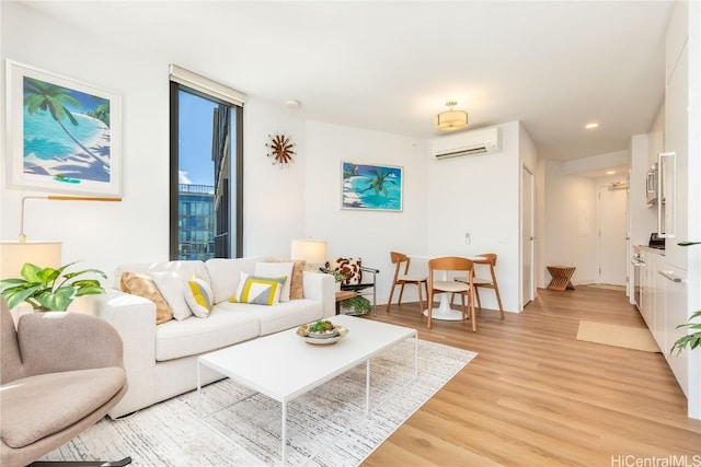 living room featuring light wood-type flooring and a wall unit AC