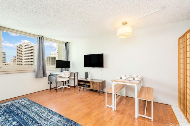 office space featuring hardwood / wood-style floors and a textured ceiling