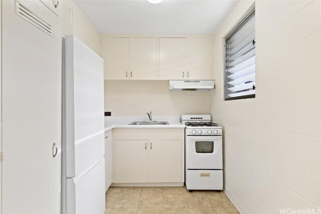 kitchen with white cabinetry, sink, white range with gas cooktop, light tile patterned floors, and a textured ceiling