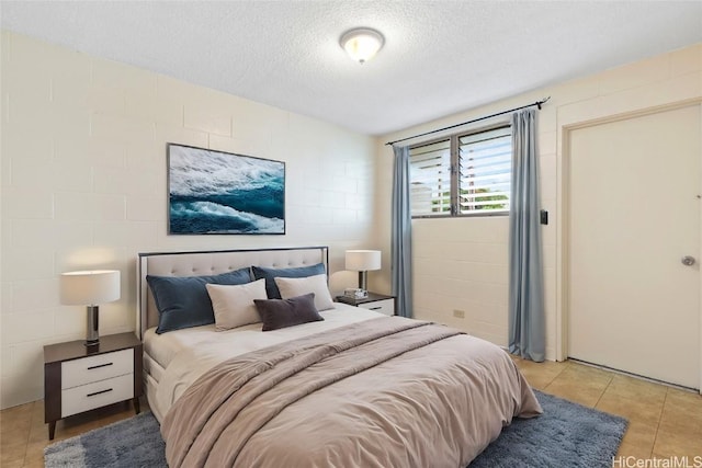 tiled bedroom featuring a textured ceiling