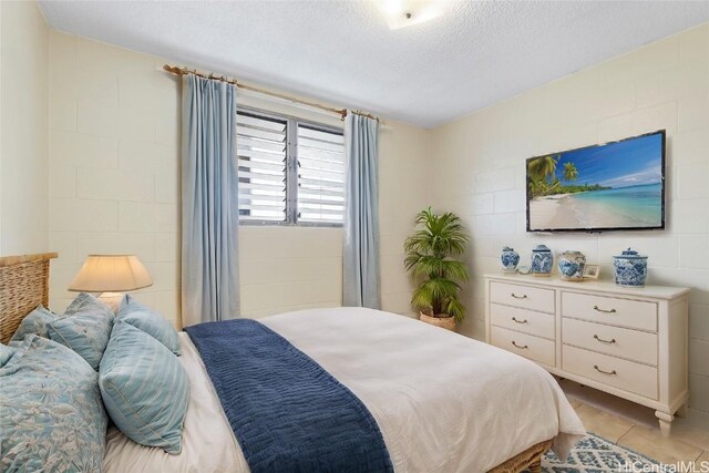 tiled bedroom with a textured ceiling