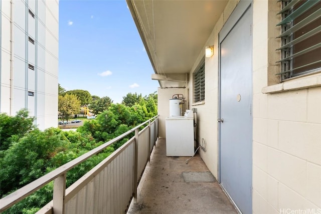 balcony featuring water heater and washer / dryer