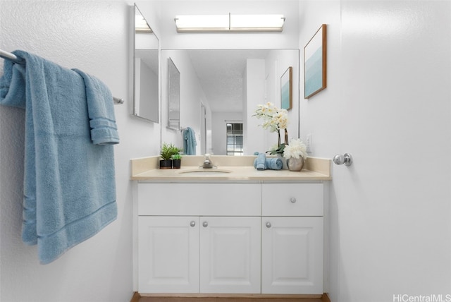 bathroom featuring a skylight, vanity, and a textured ceiling