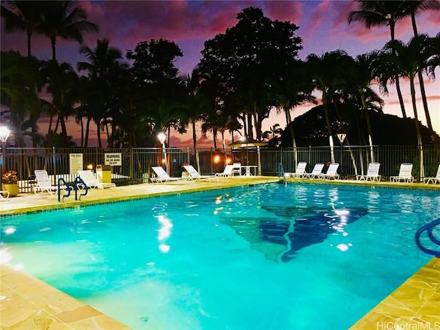 view of pool at dusk