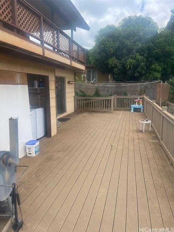 wooden terrace with washing machine and dryer