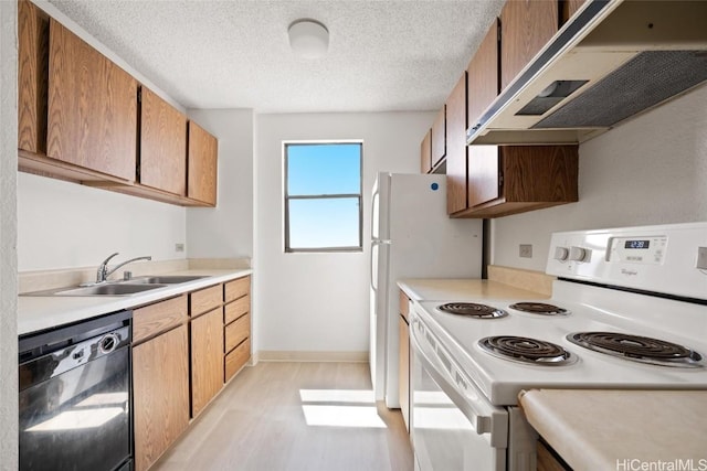 kitchen featuring a textured ceiling, white appliances, ventilation hood, sink, and light hardwood / wood-style floors