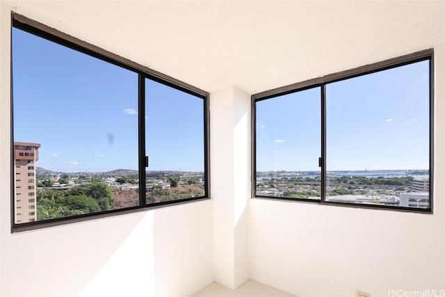 empty room with plenty of natural light and a textured ceiling