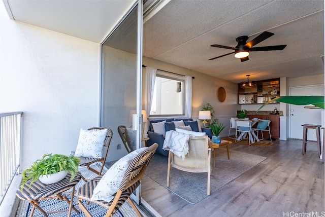 interior space featuring hardwood / wood-style flooring, ceiling fan, and a textured ceiling