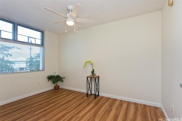 spare room featuring hardwood / wood-style floors, a textured ceiling, and ceiling fan