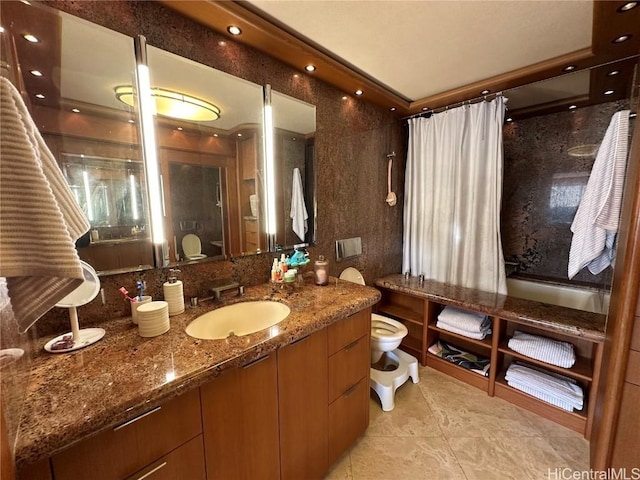 bathroom with a bidet, vanity, toilet, and tile patterned flooring