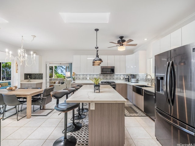 654 N Judd St Unit 654, Honolulu, HI 96817 - kitchen with stainless steel appliances, tasteful backsplash, modern cabinets, a center island, and ornamental molding