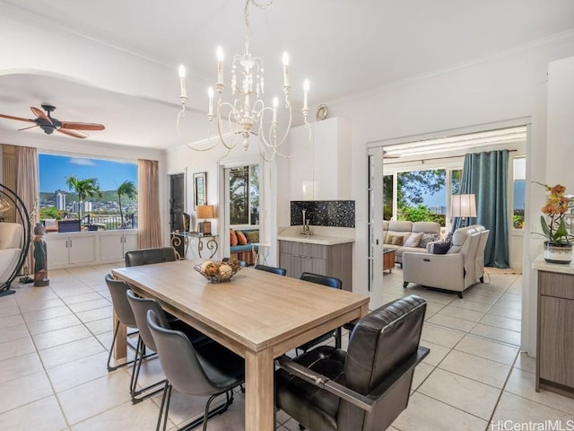 dining area featuring ceiling fan with notable chandelier, plenty of natural light, and light tile patterned flooring