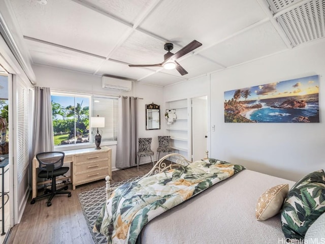 bedroom featuring a wall unit AC, ceiling fan, and hardwood / wood-style floors