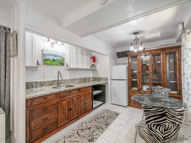 654 N Judd St Unit 654, Honolulu, HI 96817 - kitchen featuring freestanding refrigerator, a chandelier, brown cabinetry, light stone countertops, and ornamental molding
