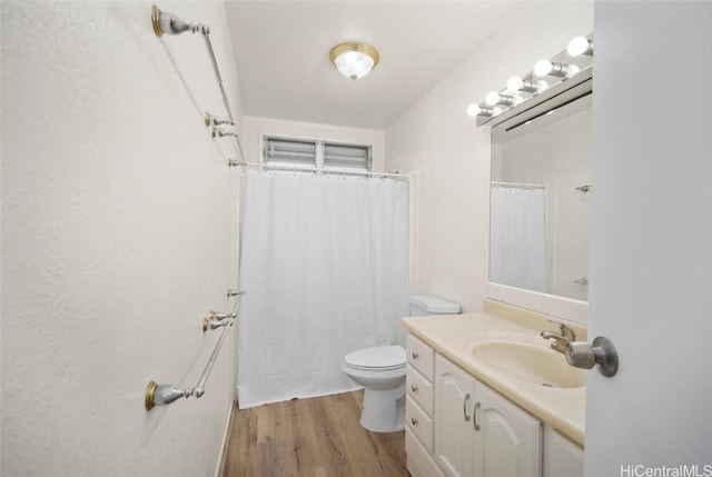 bathroom featuring vanity, toilet, and wood-type flooring