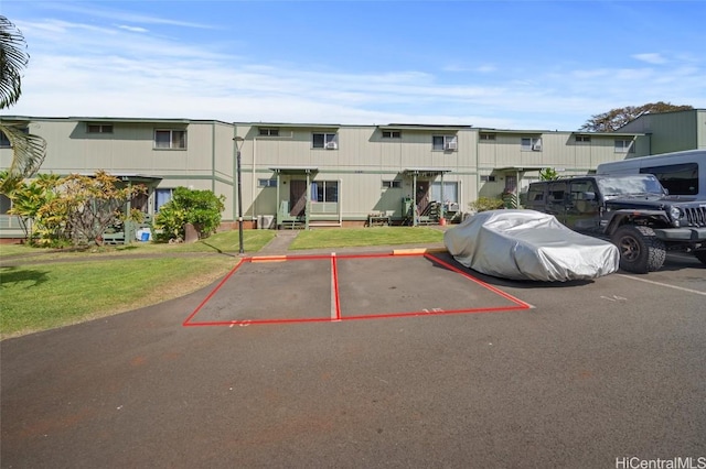 view of parking / parking lot with a yard