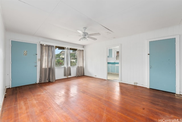 empty room with ceiling fan and hardwood / wood-style flooring