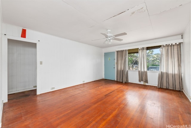 spare room with hardwood / wood-style floors and ceiling fan