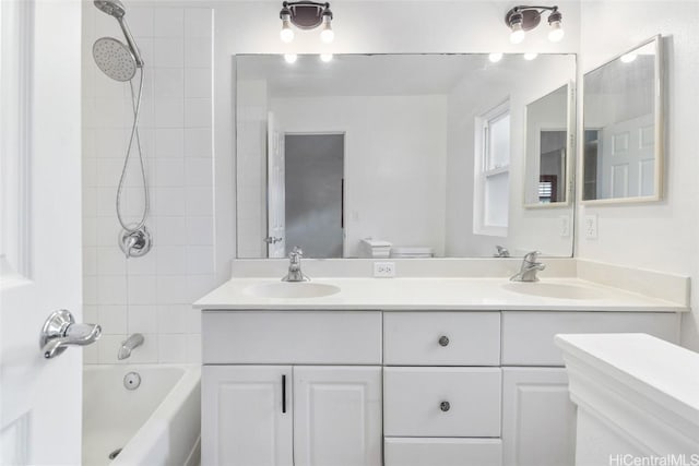 full bathroom with vanity, toilet, and tiled shower / bath