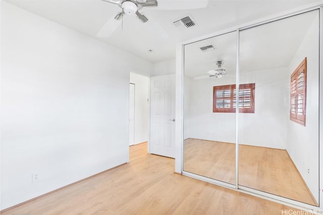 unfurnished bedroom featuring a closet, ceiling fan, and hardwood / wood-style floors