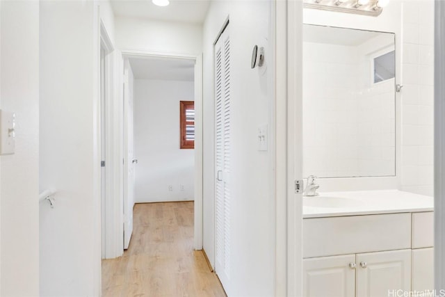 hall featuring sink and light wood-type flooring