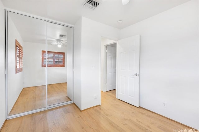 unfurnished bedroom featuring hardwood / wood-style floors and a closet