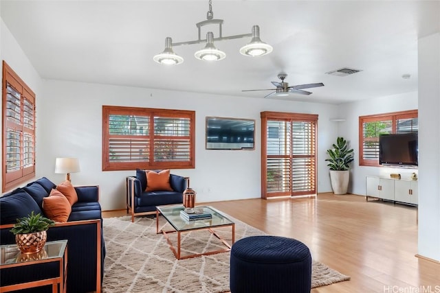 living room with hardwood / wood-style flooring and ceiling fan